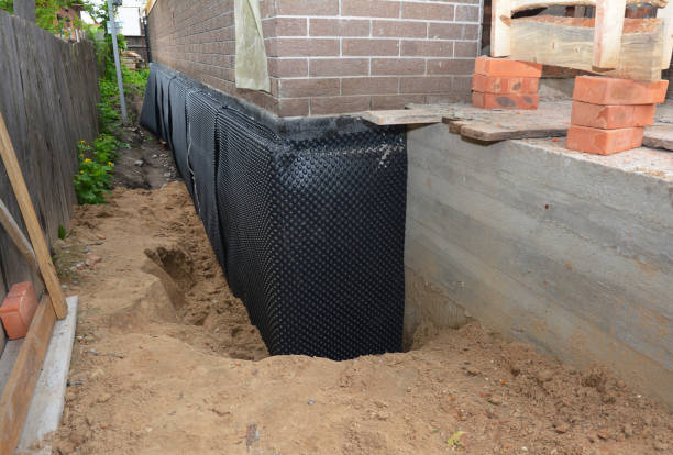 Happy homeowners after waterproofing job in Piqua